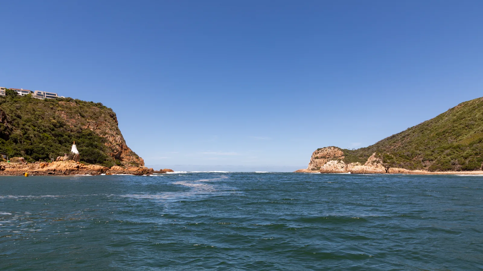 The Knysna Heads — two sandstone cliffs framing the narrow channel between lagoon and ocean