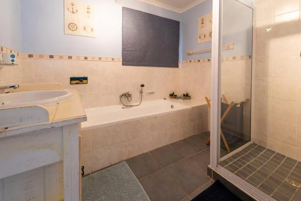 Bathroom with bathtub, sink vanity, and separate shower enclosure