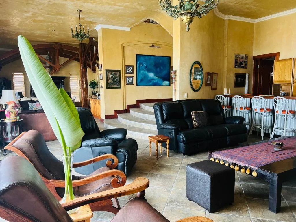 Spacious lounge with leather seating, TV, and pool table entertainment