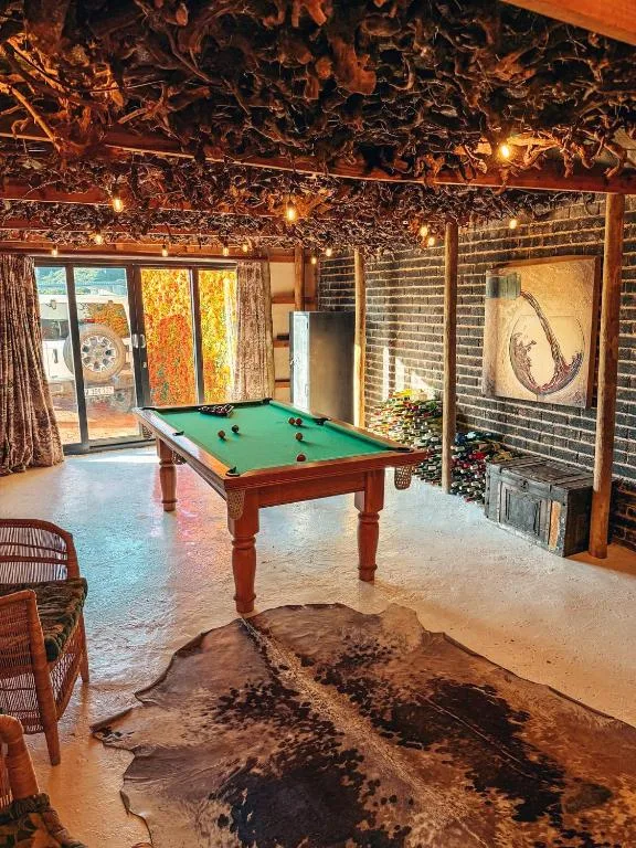 Recreation room with pool table, rustic decor, and ocean views through windows