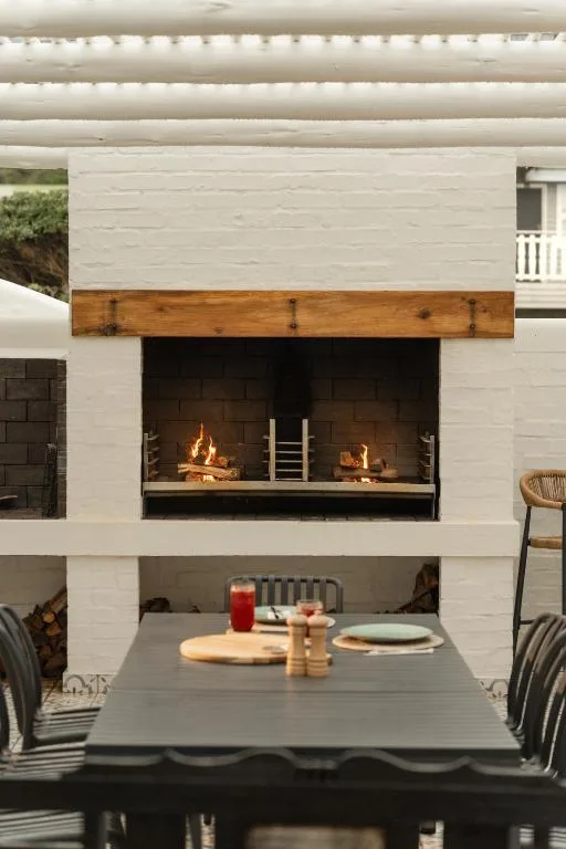 Outdoor dining area with fireplace and comfortable seating space