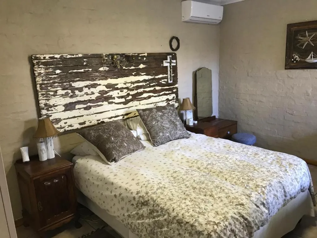 Cozy bedroom with rustic wooden headboard and patterned bedding