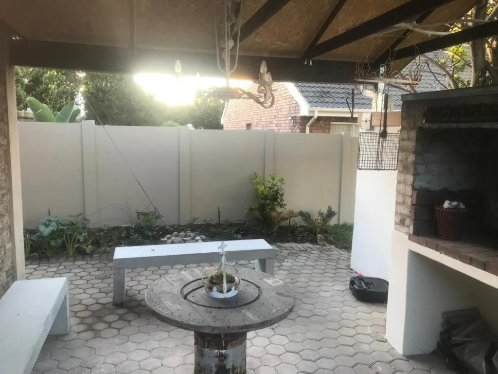 Covered patio area with central water feature and wooden beams overhead