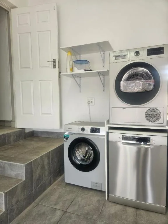 Modern laundry room with stacked washer and dryer appliances