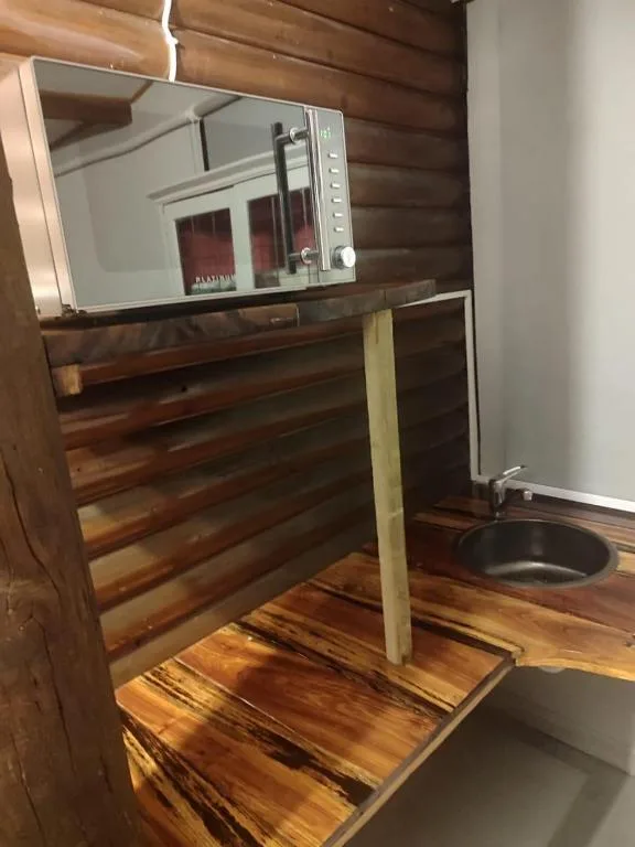 Built-in microwave and oven in wooden kitchen cabinetry with countertop