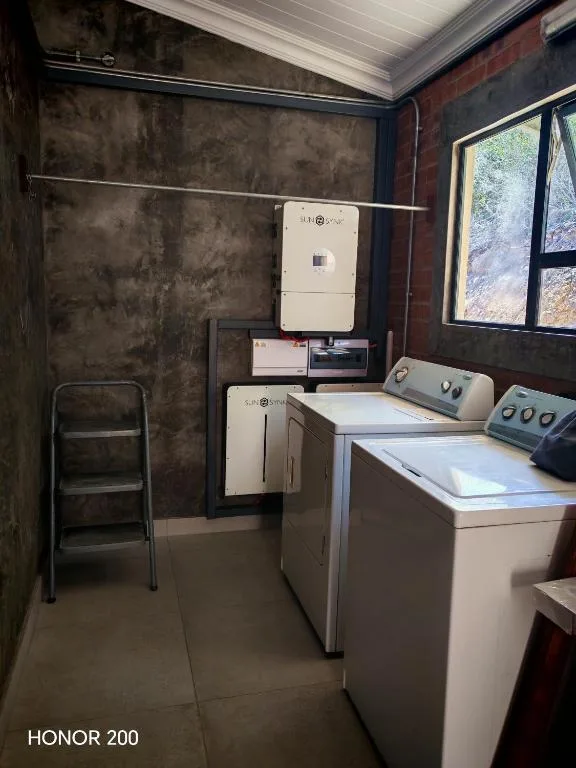 Laundry room with washing machine, dryer, and utility sink