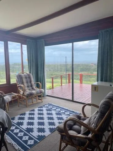 Spacious lounge with sea view through large glass doors and windows