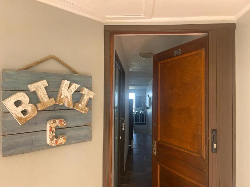 Rustic BIKE sign decoration hanging on apartment entrance wall