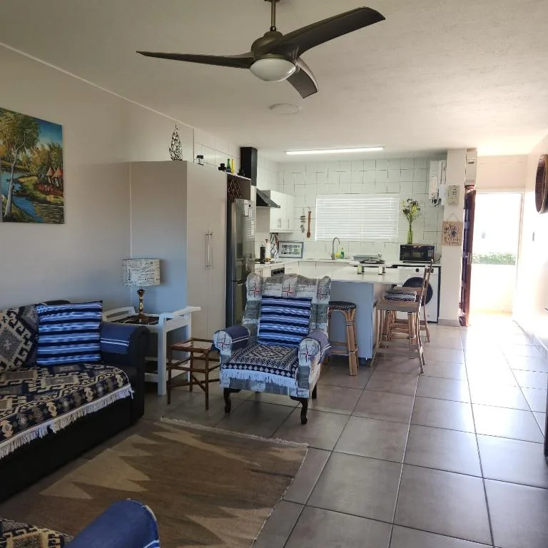 Open-plan lounge with blue striped chairs and sofa seating area