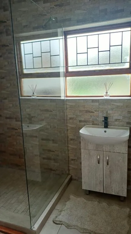 Modern bathroom with glass shower enclosure and white vanity sink