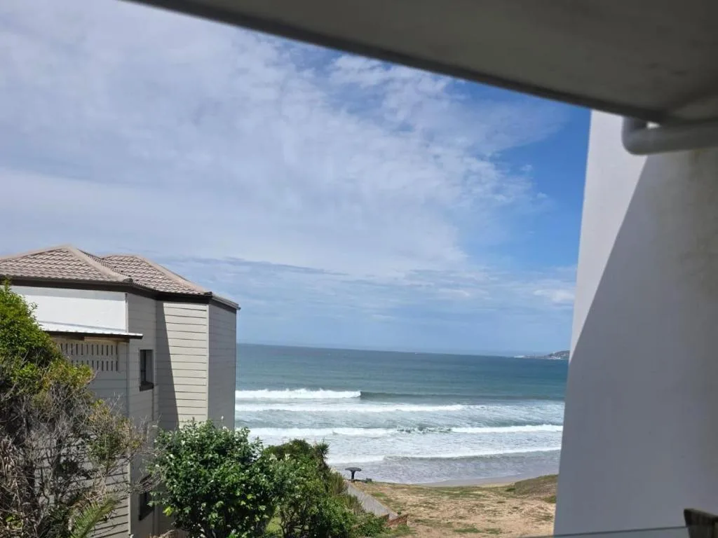 Ocean waves and sandy beach visible from property overlooking coastline