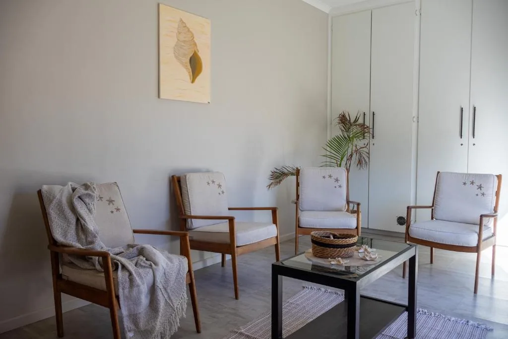 Bright lounge with mid-century modern chairs and coastal decor accents
