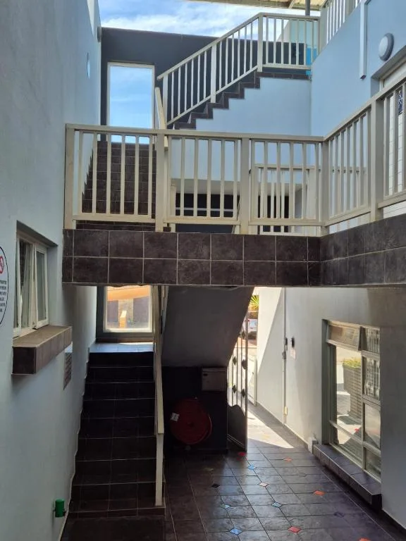Interior courtyard with staircase, railings, and tiled flooring
