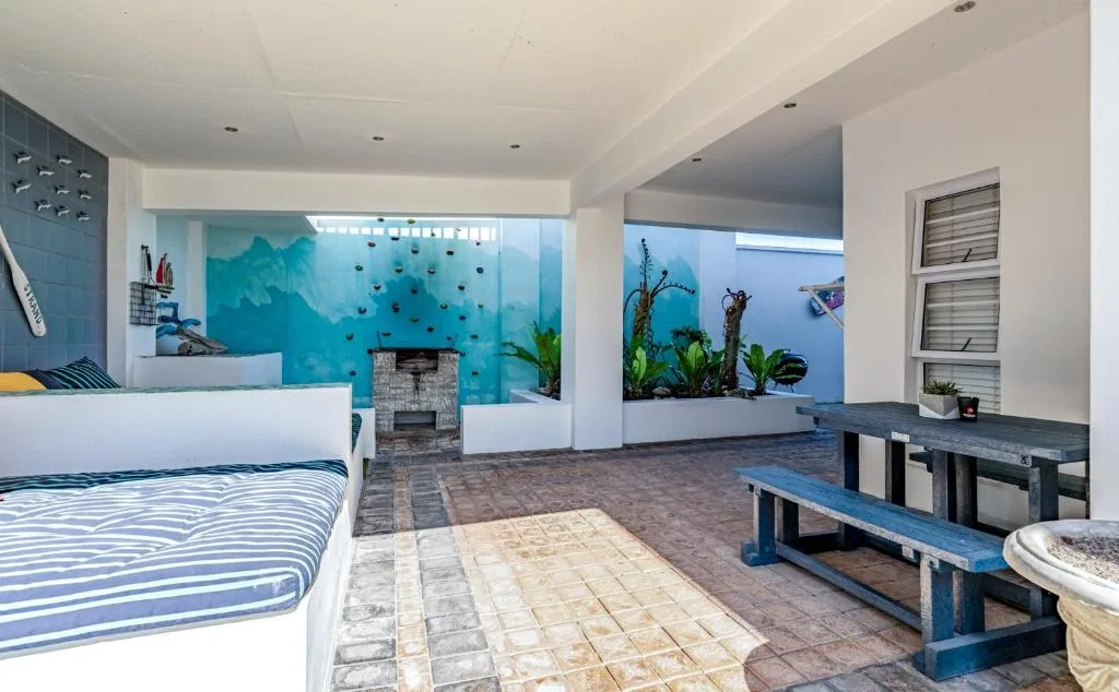 Spacious bedroom with ocean-themed mural and fireplace feature
