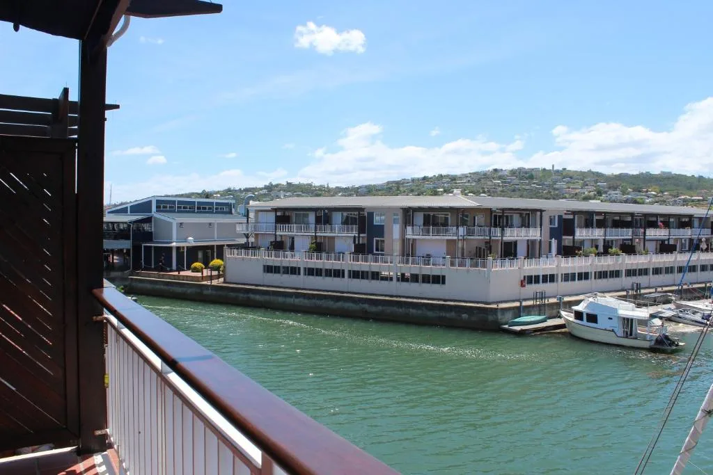 Waterfront lagoon view with boats and residential buildings across water