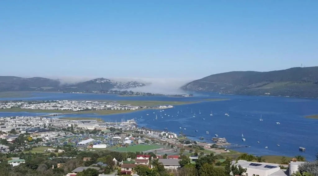 Panoramic view of Knysna Lagoon with sailboats and surrounding hills