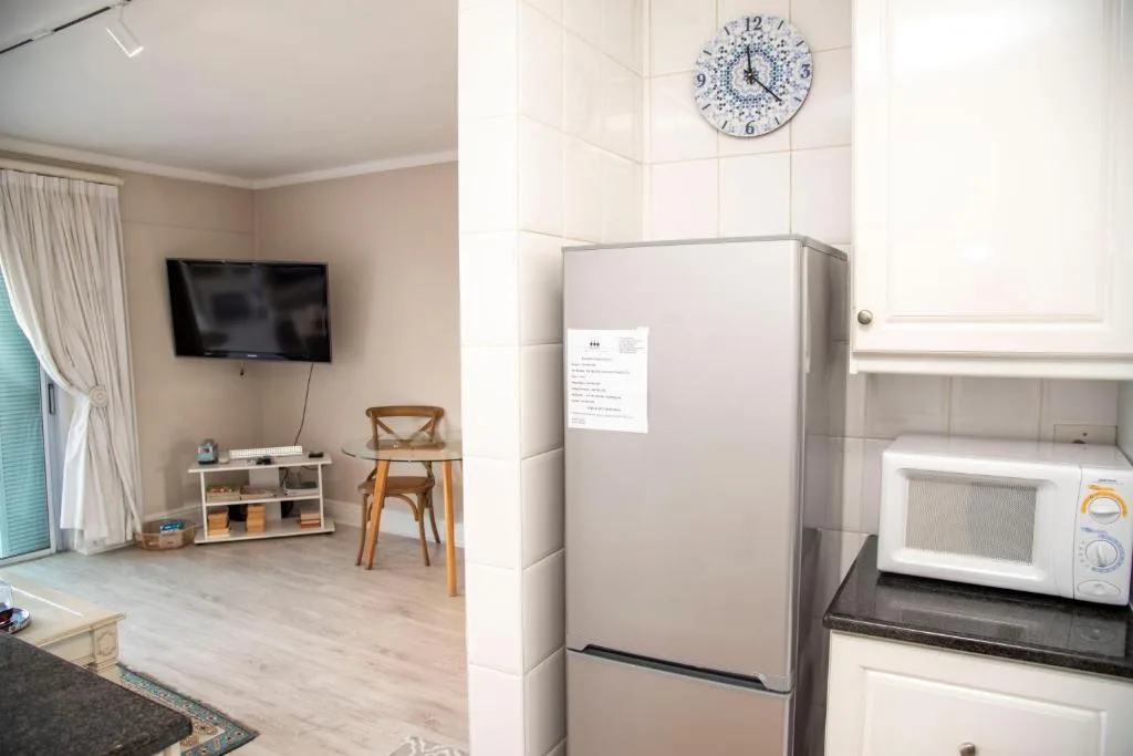 Apartment kitchen featuring stainless steel refrigerator and microwave appliances