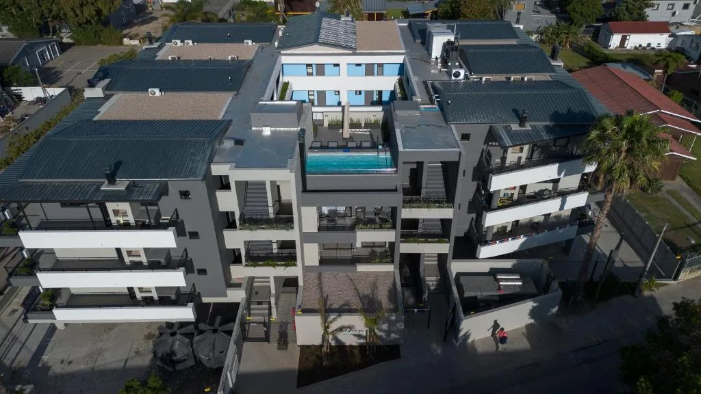 Modern apartment building with rooftop pool, aerial view of contemporary architecture