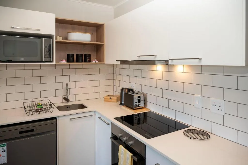 Modern kitchen with white cabinetry, subway tile backsplash, and stainless steel appliances