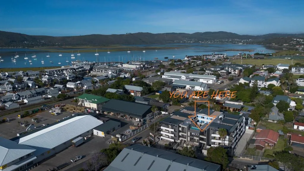 Aerial view of Knysna lagoon with boats and surrounding hillside town