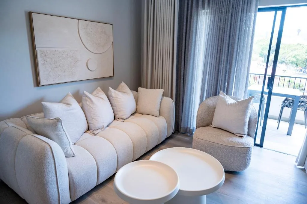 Contemporary lounge with cream sectional sofa and ocean view doors
