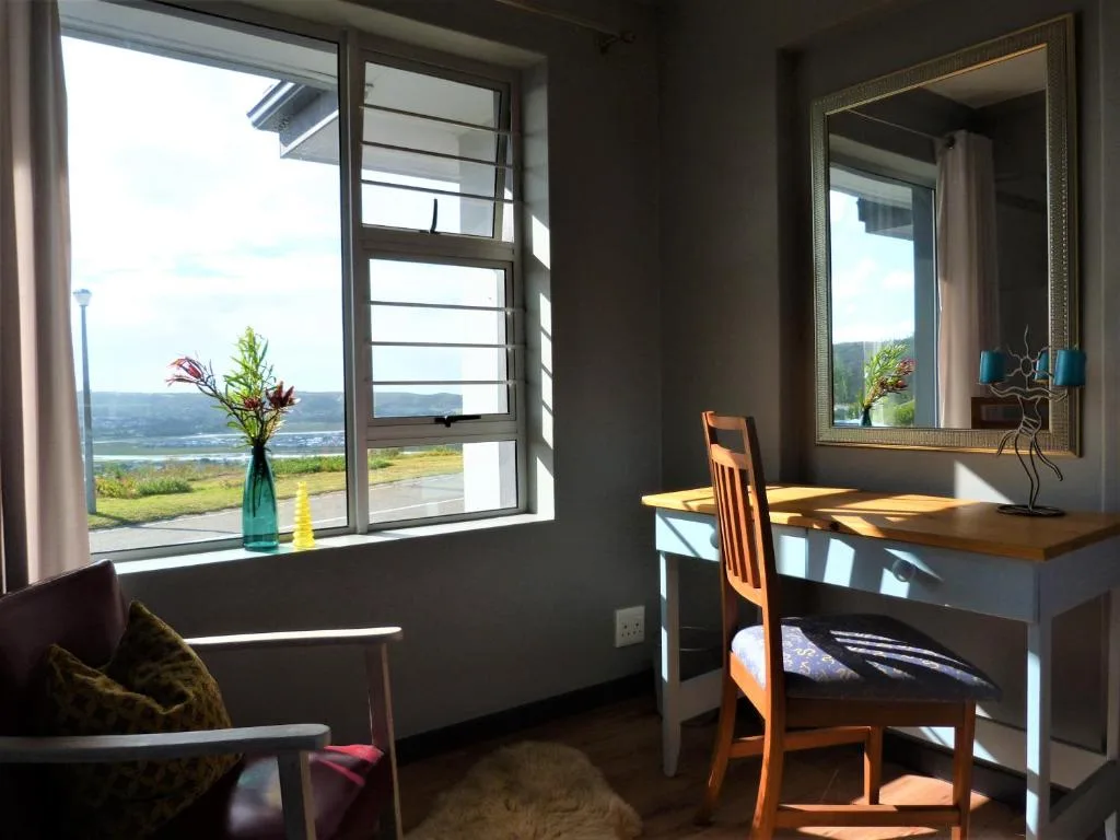 Scenic lagoon and valley vista through large modern windows