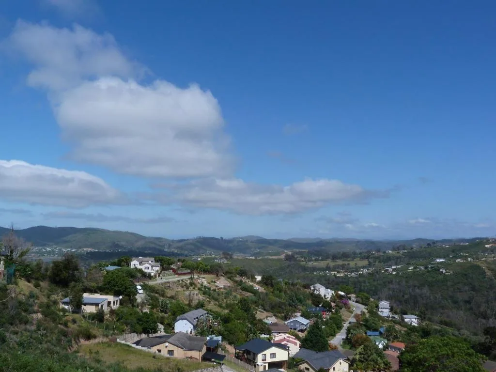 Panoramic view of Knysna valley with rolling hills and scattered homes below