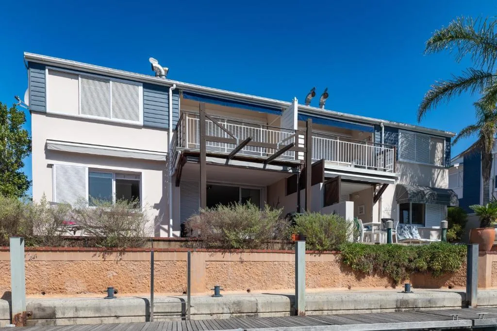 Modern two-story beachfront apartment with deck and garden fence