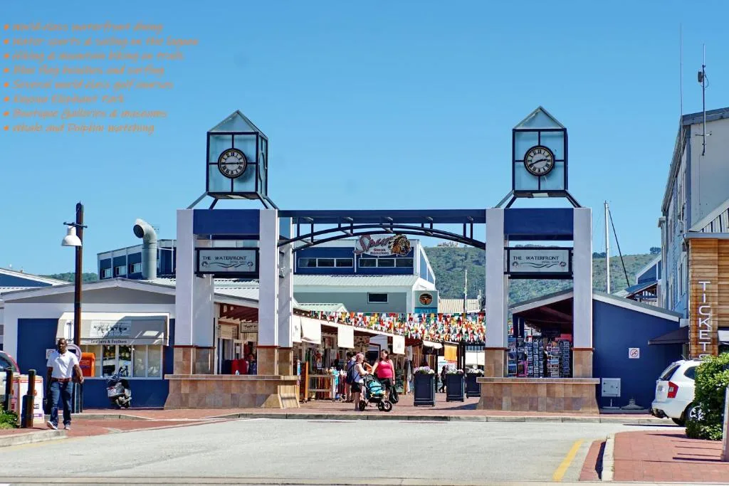 Scenic view of Knysna waterfront with iconic clock towers and harbor