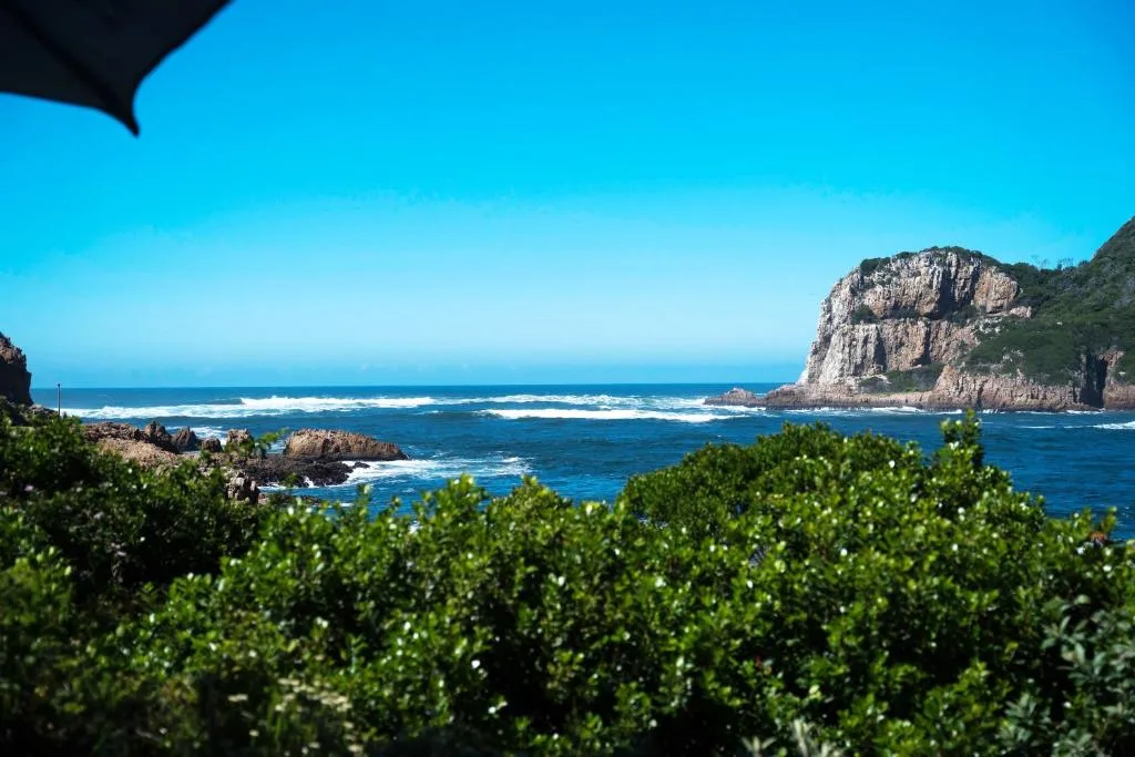 Scenic coastal view of rocky cliffs and turquoise ocean waters from property