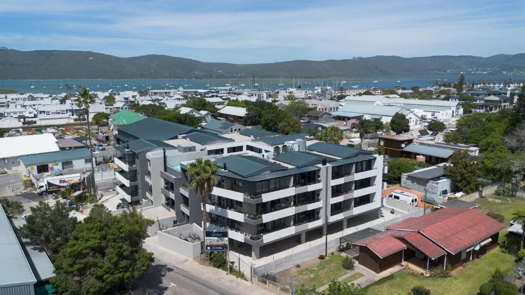 Aerial view of modern apartment building overlooking Knysna lagoon and marina