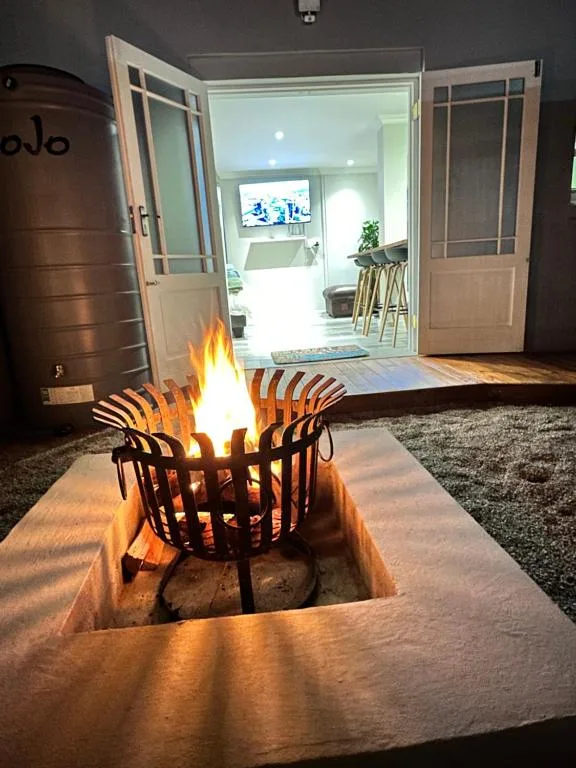 Sunken fire pit with lit flames on outdoor patio area