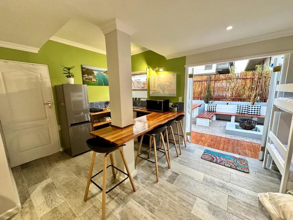 Modern kitchen with lime green walls, stainless steel appliances, wooden island with seating