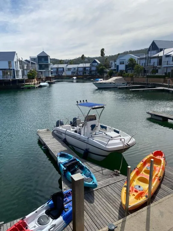Waterfront holiday homes with moored boats and calm lagoon waters