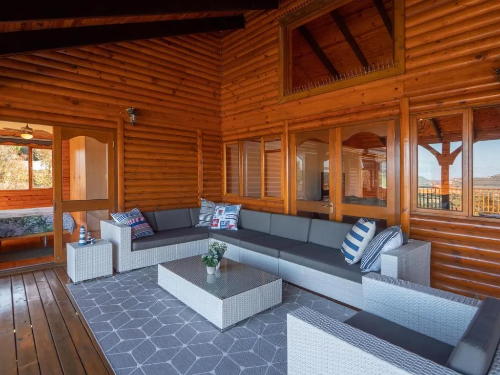 Covered deck with outdoor seating, wicker furniture, and scenic views