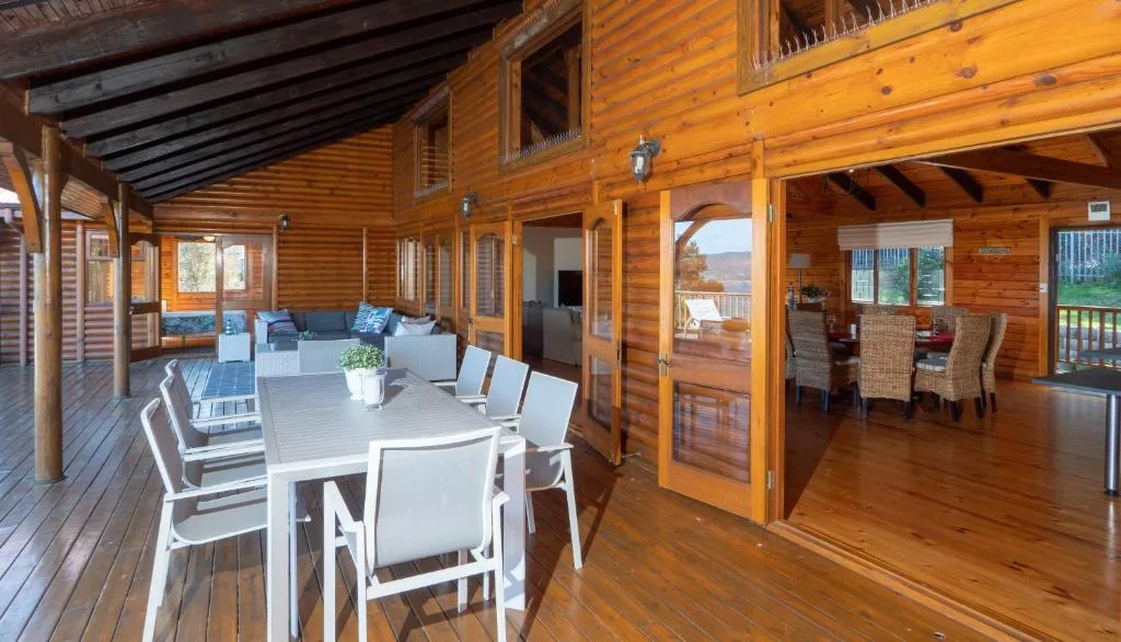 Spacious wooden deck with outdoor dining table and mountain views