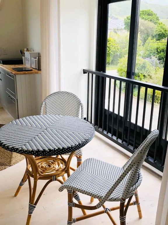 Small bistro table and chairs on balcony with scenic valley views