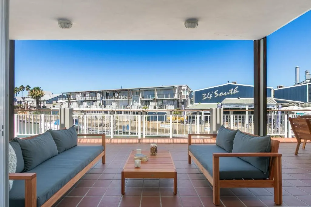 Spacious waterfront deck with outdoor seating and Knysna harbor views