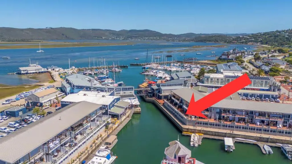 Aerial view of Knysna Heads, marina, and waterfront harbor with mountains