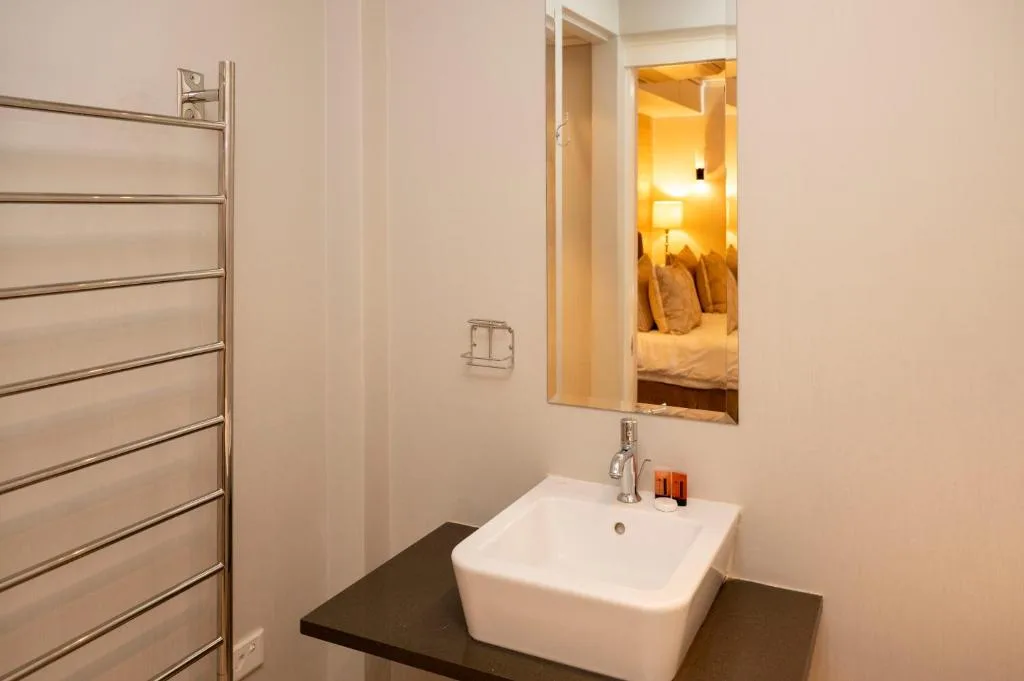 Modern bathroom with white basin sink and heated towel rail rack