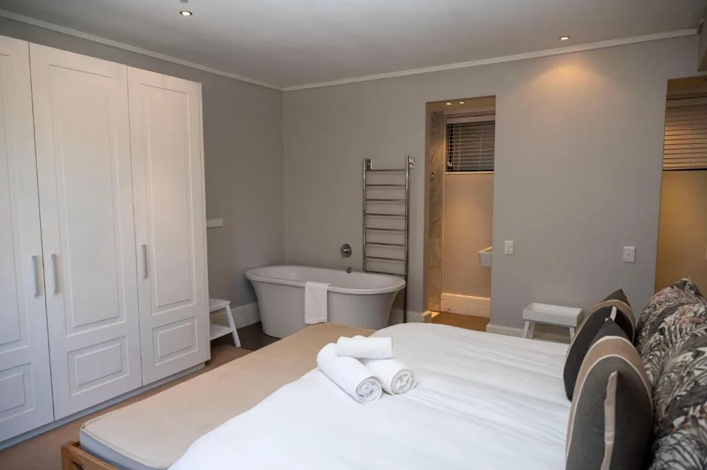 Spacious bedroom with freestanding bath and modern furnishings throughout