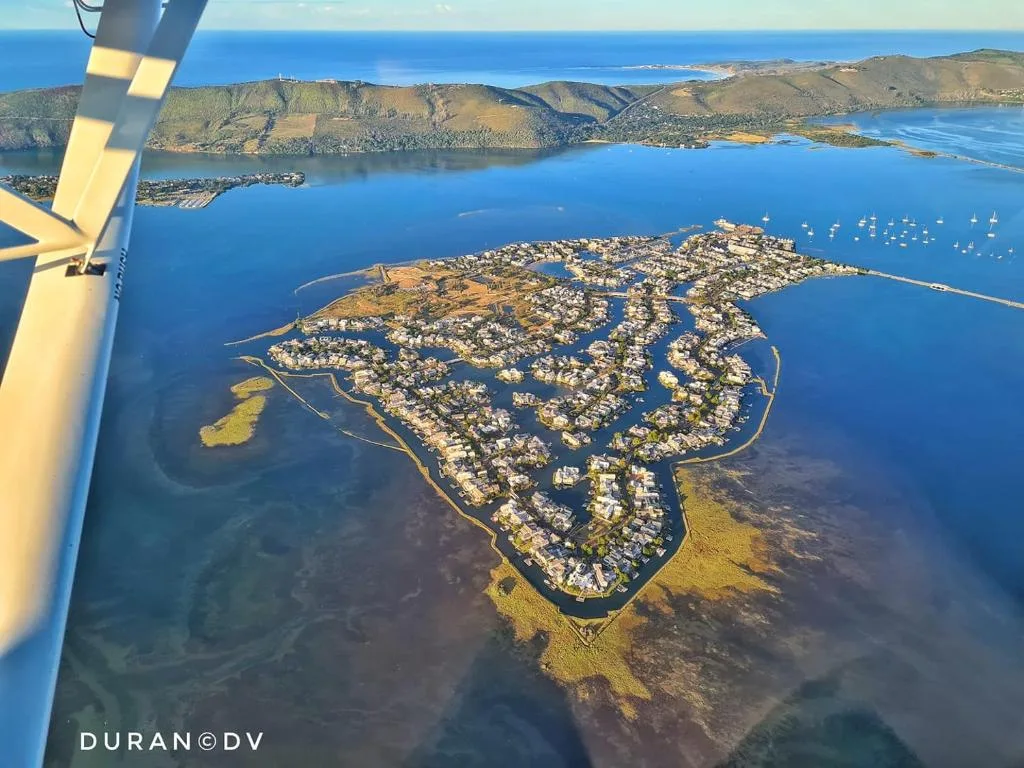 Aerial view of Knysna lagoon with residential development and surrounding coastline