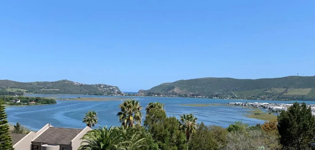 Panoramic lagoon view with lush green hills and coastal landscape