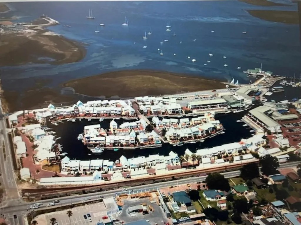 Aerial view of Knysna waterfront with moored sailboats and harbor buildings