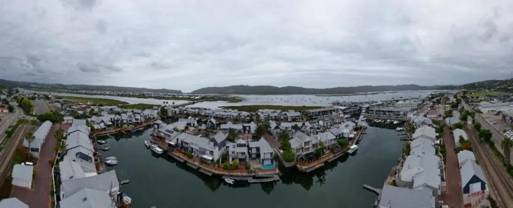 Aerial view of Knysna waterfront with lagoon, boats, and surrounding town