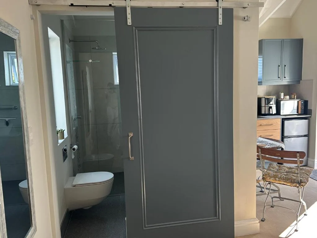 Modern bathroom with frameless shower enclosure and white toilet fixture