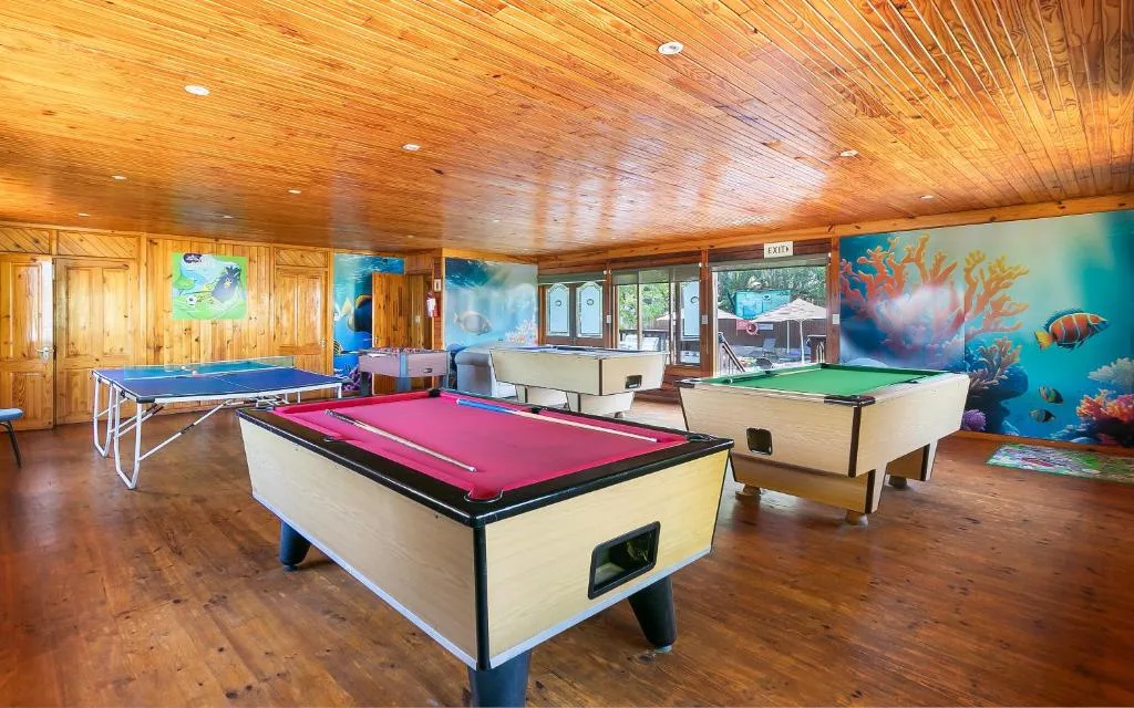 Game room with pool tables, ping pong, and wooden ceiling