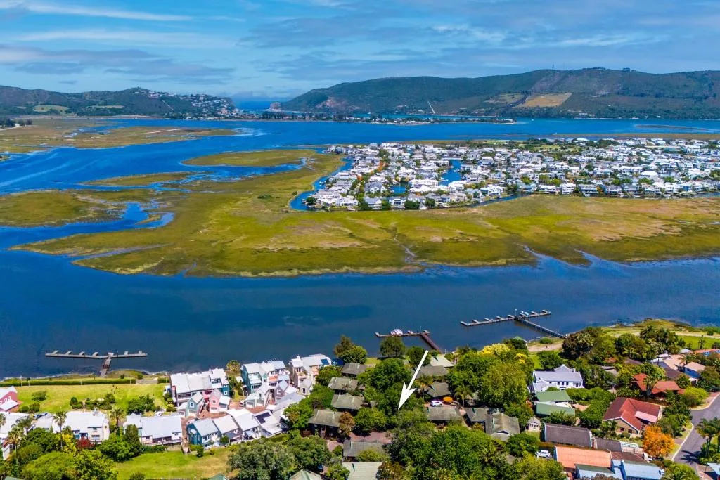 Aerial view of Knysna Lagoon with property nestled among gardens and trees