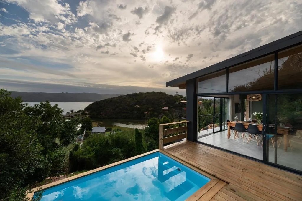 Scenic lagoon and forested hillside vista from modern waterfront property