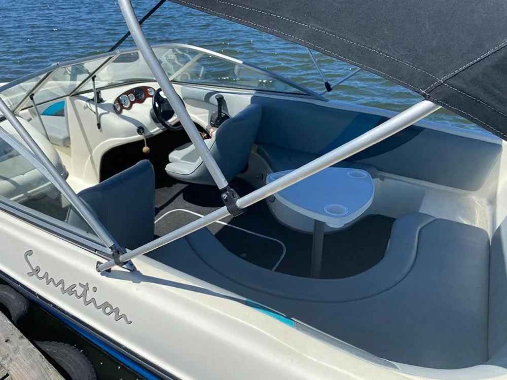 Speedboat with blue seating and control panel moored on water